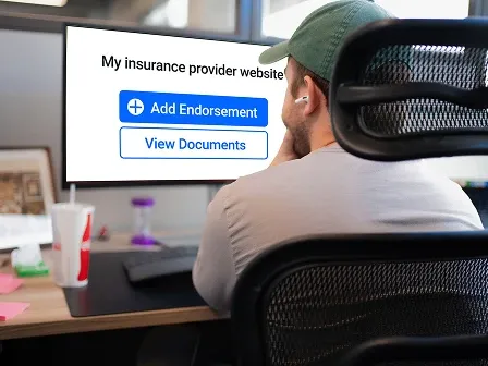 A man managing property and casualty insurance digital transformation policy on a desktop