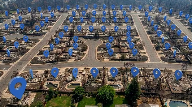 Image showing an aerial view of a fire-damaged neighborhood with location pins marking the former structures