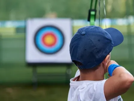 boy shooting bow for accuracy