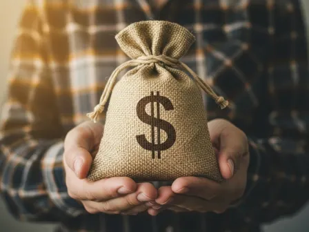 Hands holding a heap of money