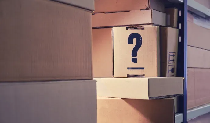 cardboard box with question mark painted on the side