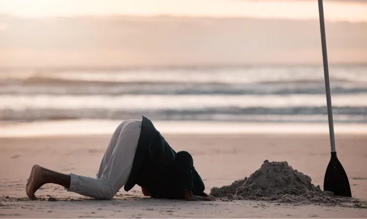 Person sticking head in a hole