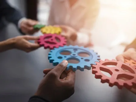 Hands holding gears as they shift
