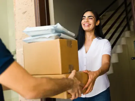 Woman receiving some boxes and packages at her deliverable address