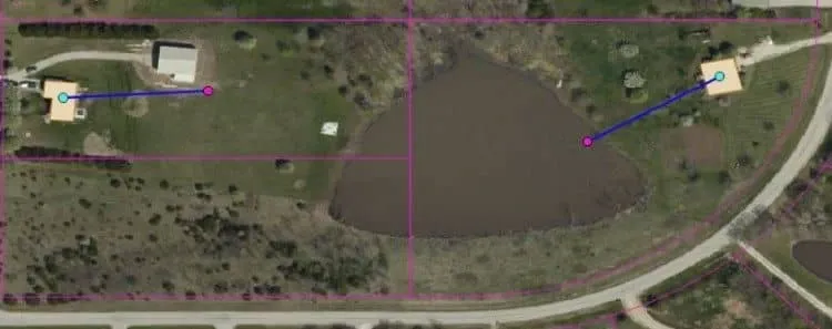 Aerial view of rural parcels outlined in purple, showing two homes