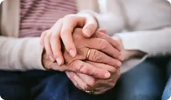 A couple holding hands after being approved for real estate financing