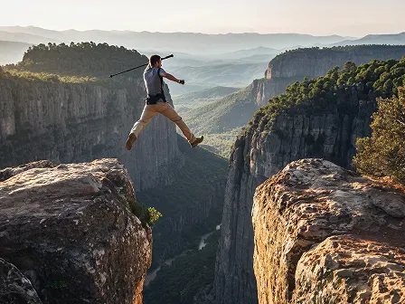 An image displaying a man leaping across a major gap/chasm
